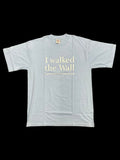 Light blue t-shirt with white I walked the wall text on